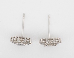 A pair of white metal (stamped 750) and diamond cluster set flower head ear studs, the central stone diameter approximately 6.5mm, overall diameter 9mm, gross weight 2.8 grams, no butterflies. Condition - fair to good